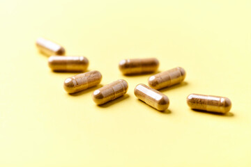 Carnitine capsules. Concept for a healthy dietary supplementation. Bright paper background. Soft focus. Close up.