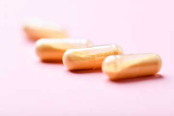 Coenzyme Q10 capsules. Antioxidants. Concept for a healthy dietary supplementation. Bright paper background. Soft focus. Close up. Copy space.