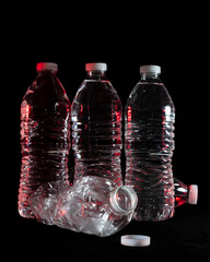 Plastic water bottles on a black background