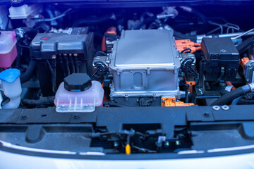 EV engine car engine block under hood electric vehicle high power and environmentally friendly zero emission. Chassis of the electric car with powertrain and power connection.
