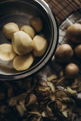 peeling potatoes, cooking at home