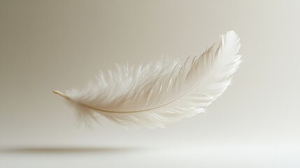 Obraz premium Single White Feather Floating Gently Against Beige Background