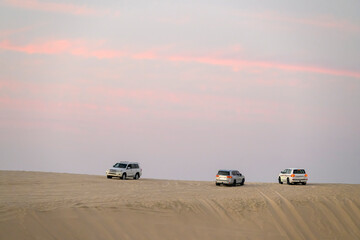 Desert landscape and off-road vehicles on desert safari in Doha, Qatar