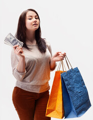 Young happy woman enjoying her shopping experience with dollar bills in hand