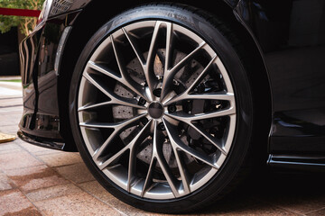 Close-up sports car tire and chrome rim