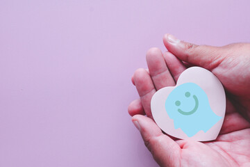 Hand holding pink heart with positive thinking in head icon concept for emotional health, personal growth,mental wellness,self-confidence,mental health.