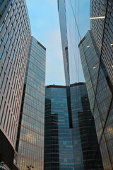 modern skyscrapers with glass panoramic windows in the business district of the European capital, wide angle view of a high rise office buildings in the financial center of the city during the day