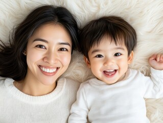 Capture the Joy of Motherhood A beautiful Asian mother smiling lovingly while engaging her child in cheerful play, this heartwarming image showcases the pure connection between parent and child The