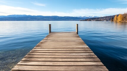 Obraz premium a wooden dock extending into the water with mountains in the background