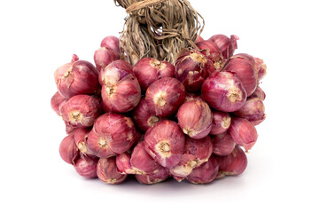 Closeup to a Pile Bunch of red shallots fresh tied together isolated on white background.