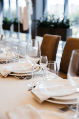 Decorating a hall for an expensive luxury wedding in a restaurant with lights, flowers, and seating details for guests