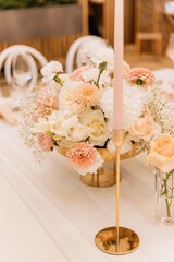 Decorating a hall for an expensive luxury wedding in a restaurant with lights, flowers, and seating details for guests
