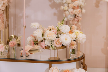Decorating a hall for an expensive luxury wedding in a restaurant with lights, flowers, and seating details for guests