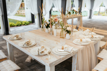 Decorating a hall for an expensive luxury wedding in a restaurant with lights, flowers, and seating details for guests