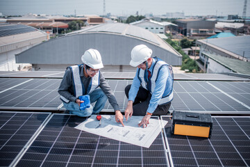 Engineers walking on roof inspect and check solar cell panel by hold equipment box and radio...