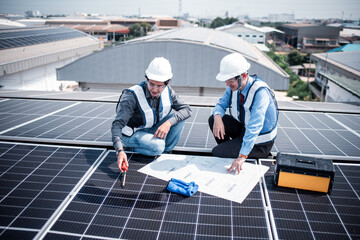 Engineers walking on roof inspect and check solar cell panel by hold equipment box and radio...