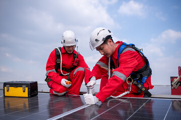 Engineers walking on roof inspect and check solar cell panel by hold equipment box and radio...