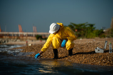 Scientist analysis professional wearing glasses and safety glove under working analysis water...