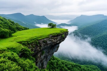 Fototapeta premium An awe-inspiring summer scenery captured from above, showcasing a foggy mountain range and clouds merging with the setting sun, enveloping the wilderness in a serene and majestic air of nature
