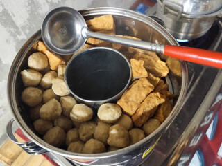 A pile of meatballs in a complete package with tofu.