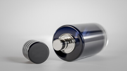 A bottle of perfume with a cap on top. The bottle is blue gradient glass premium photo 3d render
