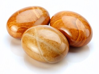 Three Smooth Oval Light Brown Stones Isolated on White Background - Natural Texture Stock Photo