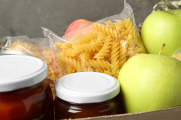 Different food products for donation in box, closeup