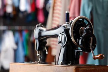 Vintage sewing machine with thread in workshop, closeup