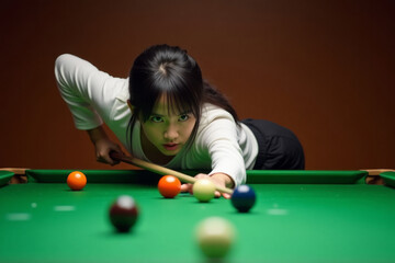 Fototapeta premium Pool Player in Action. Young woman in white sweater takes aim during game of pool, focused intently on colored balls on green felt table.
