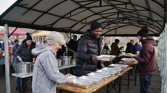 Compassionate man serving food to the homeless