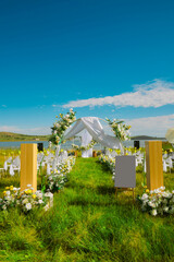 Romantic lawn wedding setting under the clear sky by the lake