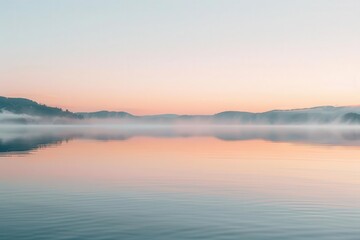 Naklejka premium Serene lake at dawn with mist and pastel colors reflecting on calm waters.