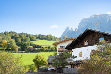 View of the Italian Alps Dolomites with traditional town architecture in view. 