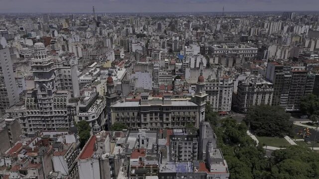 Drone flies to the right, facing south in front of Palacio Barolo, Plaza Mariano Moreno and the National Congress in Buenos Aires, Argentina