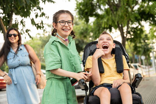 Cheerful family enjoying outdoor activities with special needs children