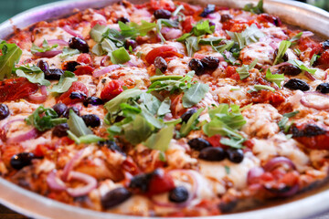 Freshly Baked Pizza with Various Toppings and black olives 