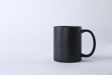 One blank black mug on white background. Mockup for design