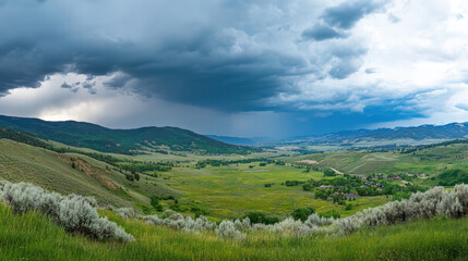 Obraz premium panoramic view of storm approaching mountain valley, showcasing lush green fields and dramatic clouds. scene evokes sense of nature power and beauty