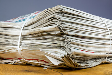 Tied pack of paper newspapers on wooden table