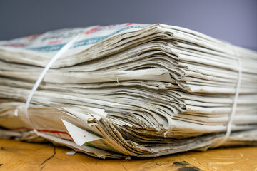 Tied pack of paper newspapers on wooden table