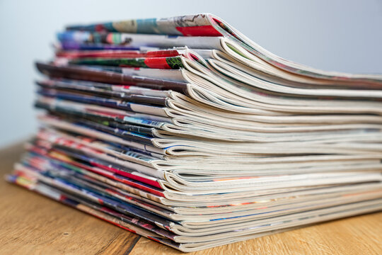 A pile of colorful magazines lying on wooden table