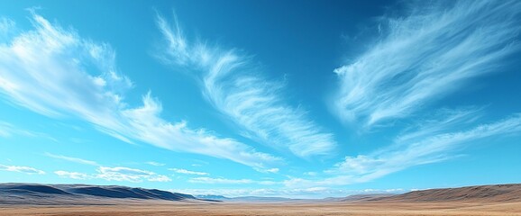 Fototapeta premium Dramatic cloudscape over a vast, flat desert landscape under a vibrant blue sky.