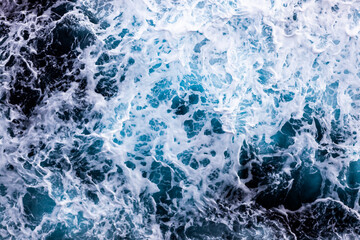Sea water texture. Top view of captivating water with foam. Can be used in covers, packaging, posters, textures, brochures, art, and design projects. Picturesque nature background image.