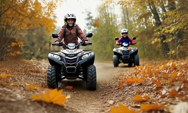 Adventurous family ride on atvs through autumn forest trail