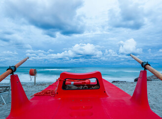 Red rescue boat in Sardinia, Italy. Mediterranean coast on a stormy day near Capo Comino, Siniscola...
