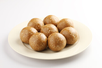 Sesame seed jaggery ball or til ke laddo and tilgul or til gul laddu served in bowl for Makar Sankranti Festival in India