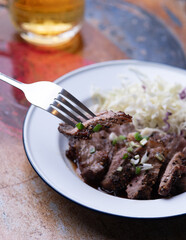 Isaan-style grilled beef, served with a side of fresh herbs and spicy
