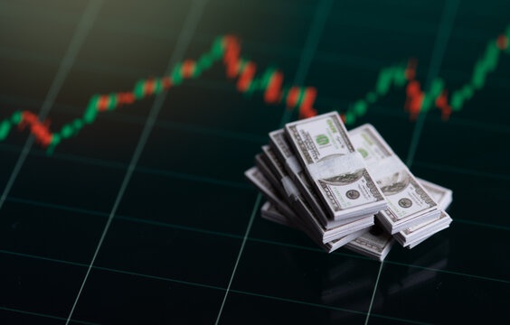 Banknotes over digital screen with real life exchange chart, USD EUR parity concept, Concept of wealth and investment
