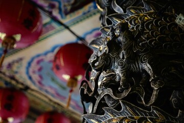 Intricate Asian temple decor with red lanterns.