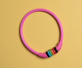 A pink combination bicycle lock, close-up